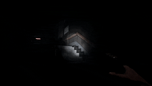 a person is pressing a button in a dark room while another person holds a light .
