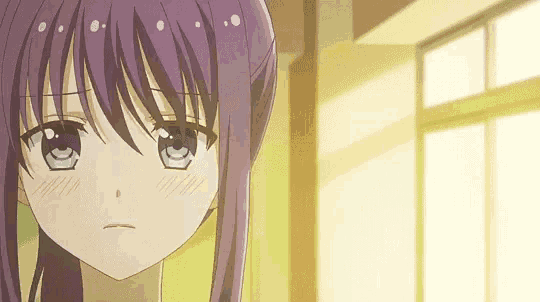 a girl with purple hair and blue eyes is looking at the camera