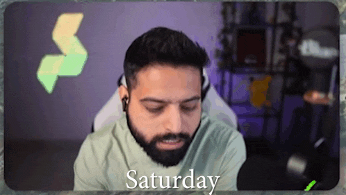 a man with a beard is wearing headphones and the word saturday is on the screen