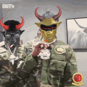 a man wearing a mask with horns is smoking a cigarette