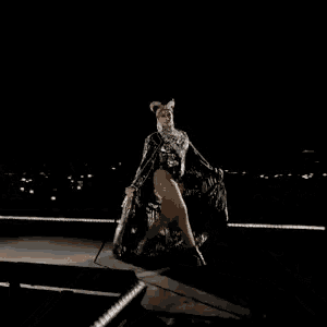 a woman in a cat costume is walking on a bridge at night