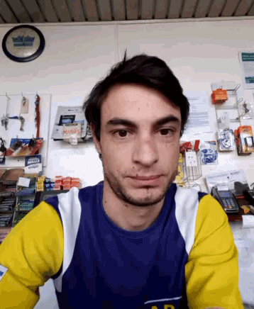 a man wearing a blue and yellow shirt with the letter a on the front