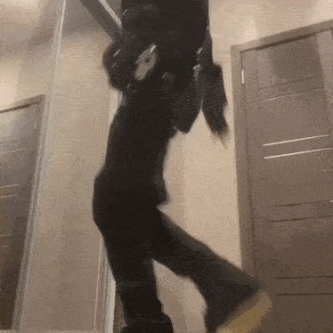 a person is dancing in front of a mirror in a room .