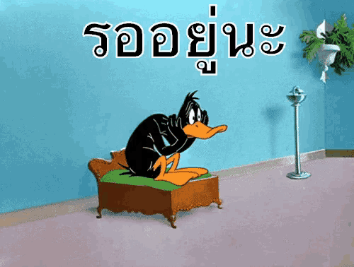 a cartoon of daffy duck sitting on a couch with a blue wall behind him