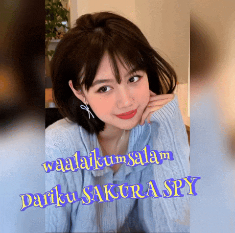 a woman in a blue sweater with the words waalaikum salam darku sakura spy