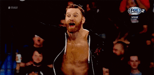 a man with a beard is standing in front of a crowd with his arms outstretched and a fox sports logo behind him