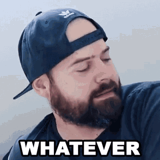 a man with a beard wearing a baseball cap and a black shirt is making a funny face .