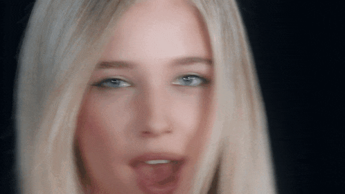 a close up of a woman 's face with blonde hair