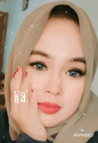 a woman wearing a hijab with the word wa written on it