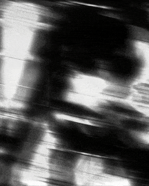 a black and white photo of a person walking