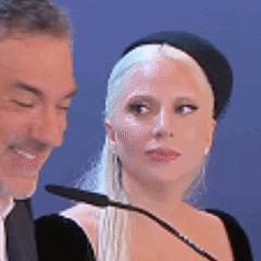 a man and a woman are standing in front of microphones