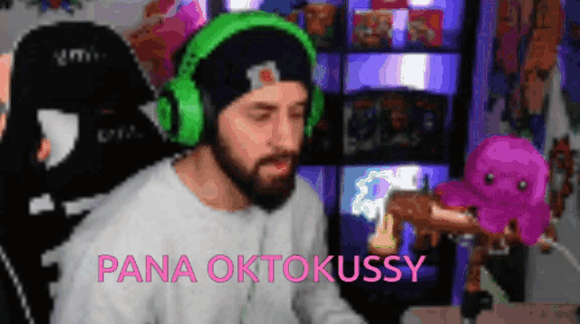 a man with a beard wearing green headphones is holding a stuffed octopus and the words pana oktokussy are above him