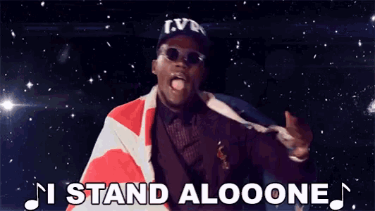 a man in a lv hat is holding an american flag