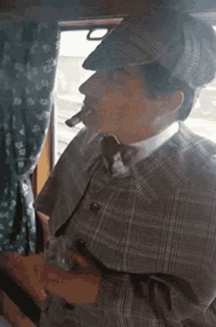 a man in a sherlock holmes costume smoking a cigar