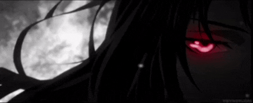 a close up of a person 's eyes with red eyes in the dark .