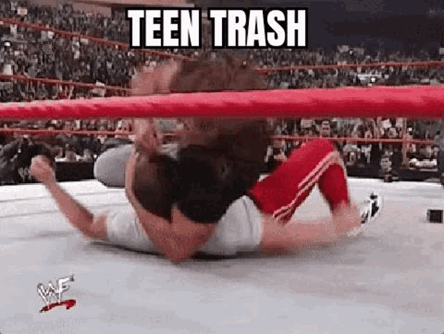 a man is wrestling another man in a wrestling ring with a caption that says teen trash .