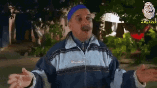a man with his arms outstretched is wearing a blue hat and a jacket