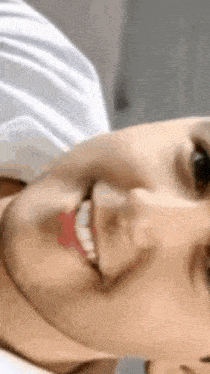 a close up of a person 's face with a smile on it
