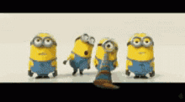 a group of minions are standing next to each other on a white surface .