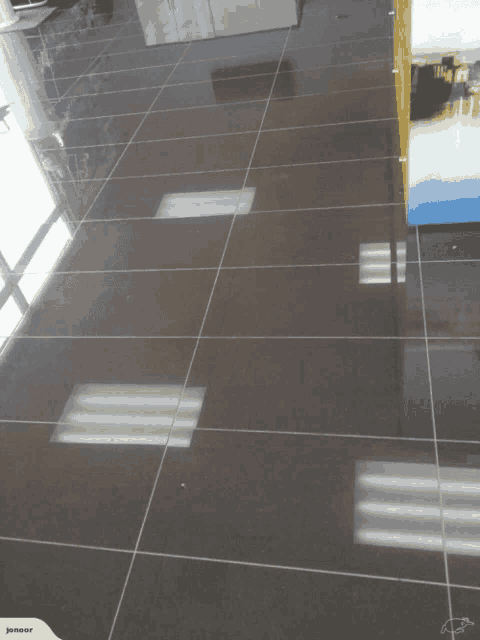 a picture of a tiled floor with a picture of a painting in the background