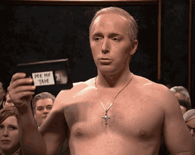 a shirtless man is holding a video tape that says pee me take