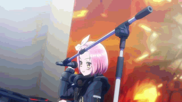 a girl with pink hair is holding a microphone in her hand