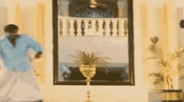 a man is dancing in front of a large mirror in a room .