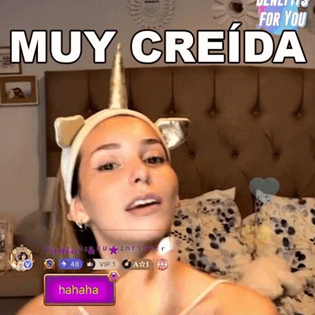 a woman wearing a headband with cat ears and a unicorn horn with the words muy creida above her
