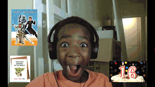 a young boy wearing headphones with a birthday card that says happy birthday