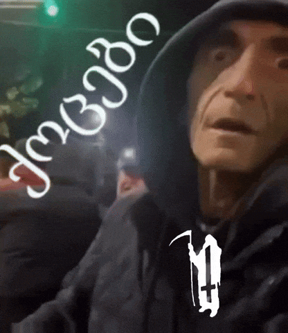 a man wearing a hooded jacket has the number 10 on his chest