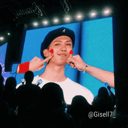 a person putting a heart on a man 's face with the hashtag gisell17