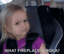 a little girl is sitting in a car seat with the words `` what fireplace in boca '' .