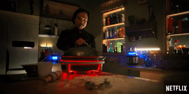 a man cooking in a kitchen with a netflix logo on the bottom right