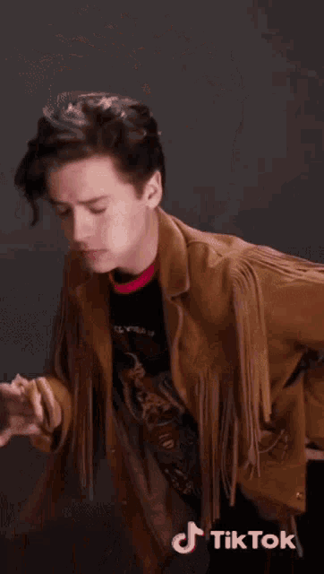 a young man is eating a mcdonald 's hamburger with a tik tok sticker on the bottom right