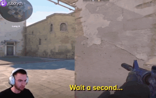 a man wearing headphones is playing a video game with the words wait a second