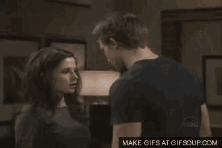 a man and a woman are kissing each other on a tv show .