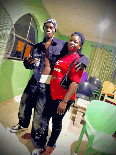 a woman wearing a red shirt that says coca cola stands next to a man