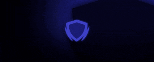 a blue shield is glowing in the dark on a dark background .