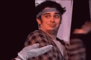 a man wearing a headband and gloves is being touched by a person .