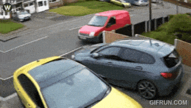 a gif from gifrun.com shows a red van driving past a yellow car