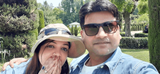 a man wearing sunglasses and a woman wearing a hat are posing for a photo