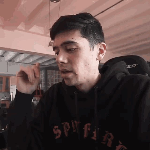 a man wearing a sweatshirt that says spitfire