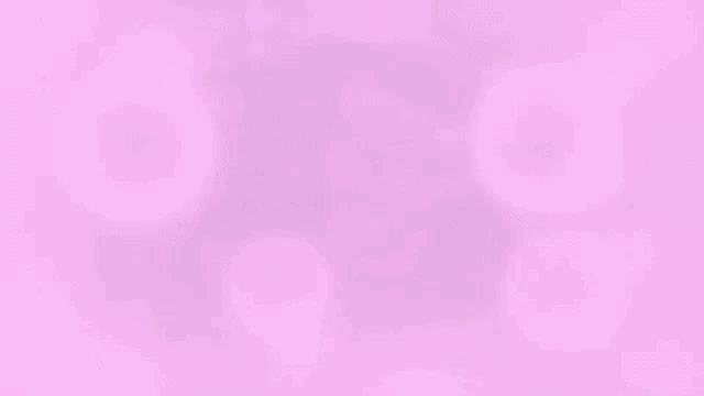 a man wearing glasses is sitting in a chair with pink bubbles coming out of his face .