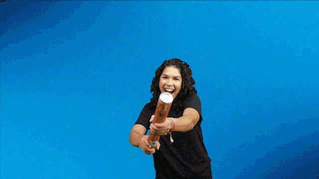 a woman is surrounded by confetti and bubbles against a blue background