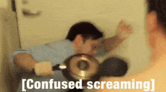 a man is standing in front of a mirror with the words `` confused screaming '' written on the bottom of the image .
