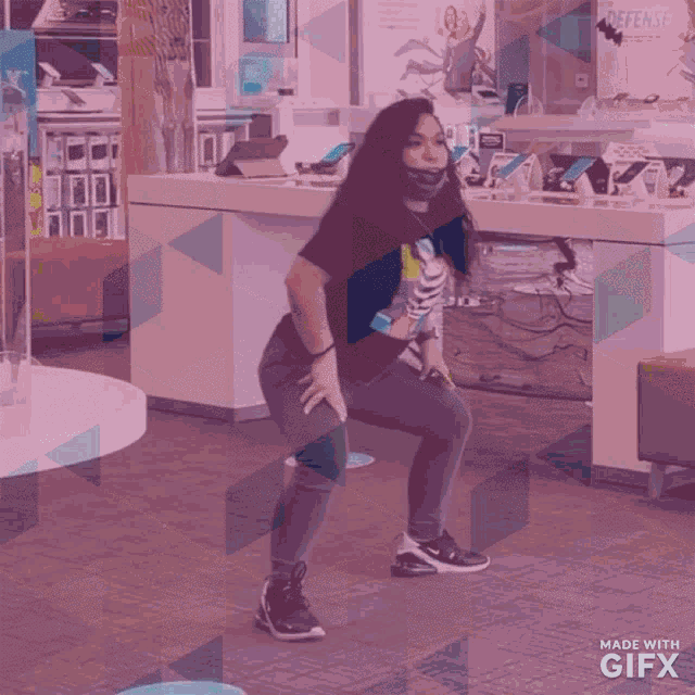 a gif of a woman dancing in a store with the words made with gifx