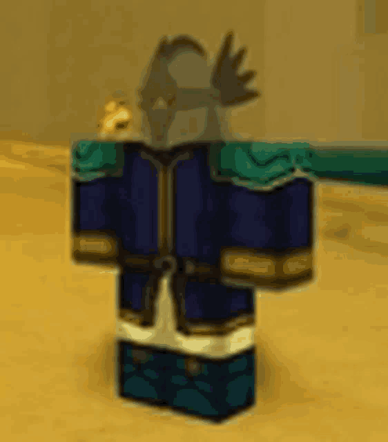 a cartoon character wearing a blue robe and a helmet is standing in the sand .