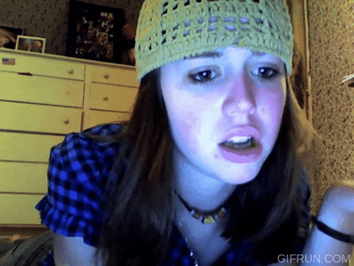 a girl wearing a knitted hat and a plaid shirt with a gifrun.com watermark on the bottom