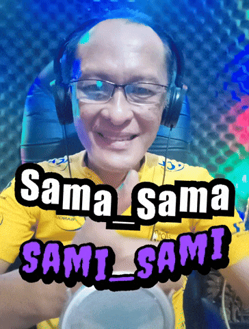 a man wearing headphones and a yellow shirt that says sama sama