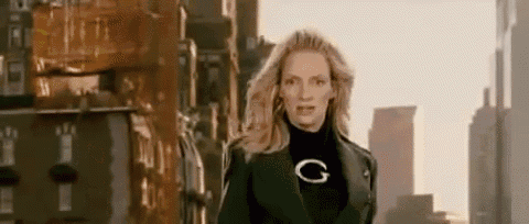 a woman is standing in front of a city skyline wearing a black jacket and a black turtleneck .